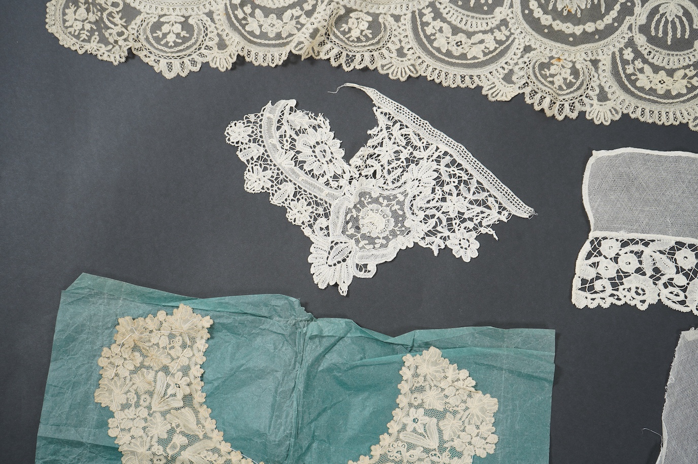 A late 19th century Brussels bobbin lace on net section of a wedding veil, Brussels bobbin lace collar, a point de gaz lace motif and two lengths of later bobbin lace trimming possibly Honiton with needle lace insertions